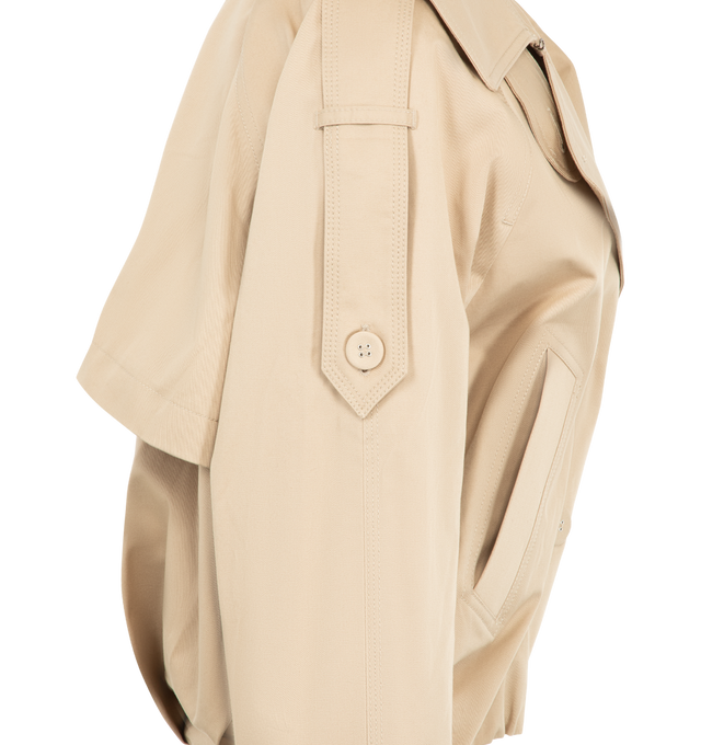 Image 3 of 3 - NEUTRAL - Acne Studios Womens Short Trench Coat is crafted from cotton twill. Features a relaxed fit, below-waist length, wide lapels, epaulettes, side pockets, sleeve tabs, balloon hem, and Acne Studios logo at the back neckline. Main Material: 99% Cotton, 1% Elastane; Lining: 100% Cotton. Made with organically grown cotton. Made in Portugal.
