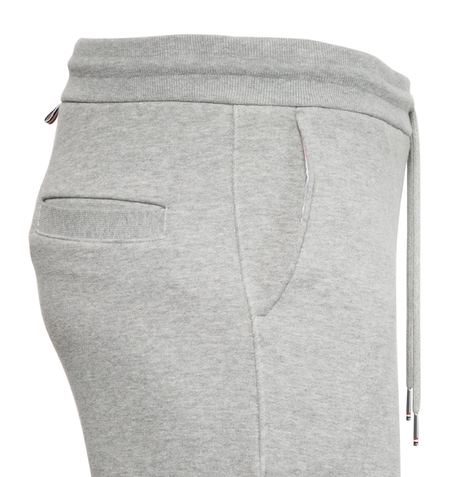Image 3 of 5 - GREY - THOM BROWNE cotton jersey sweatpants with pull-on waist featuring drawcords, side pockets and slim leg with signature stripes, logo patch and cuffed hems.  