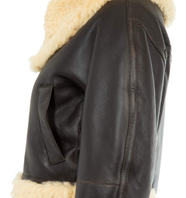 Image 3 of 3 - BROWN - JACQUEMUS Asymmetric Aviator Jacket featuring straight fit, double-sided lambskin leather shearling, asymmetric fur collar with adjustable strap, slanted zipper closure, large welt pockets, shearling fur-trimmed cuffs and hem and back yoke. 100% lamb leather. Made in Turkey.