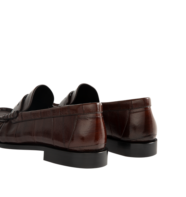 Image 3 of 4 - BROWN - Saint Laurent Mens Penny Loafers are crafted from supple eel skin leather. Feature a hand-stitched moc toe, gold-tone Cassandre hardware, classic penny loafer silhouette, and leather sole. Main Material: Eel Skin Leather; Hardware: Brass; Sole: Leather. Made in Italy.