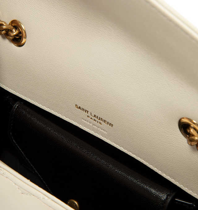 Image 3 of 3 - CREAM - Saint Laurent Women's Loulou Mini Chain Bag is crafted from lambskin leather and features the house's iconic chevron-quilted topstitching, a leather-and-chain shoulder strap, and a lightweight mini silhouette. Designed for versatile crossbody wear, this compact style is finished with bronze-toned hardware, a magnetic snap closure, a leather-lined interior, and a removable leather pouch. Main Material: Lambskin Leather. Lining: Leather. Hardware: Bronze-Toned Brass. Dimensions: 20 x 12