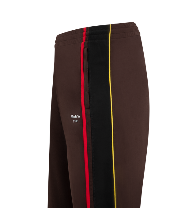 Image 3 of 3 - BROWN - MARTINE ROSE Wide Leg Track Pants featuring fleece track pants, concealed drawstring at elasticized waistband, two-pocket styling, logo embroidered at front and stripe appliqus and piping at outseams. 100% polyester. Made in Portugal.