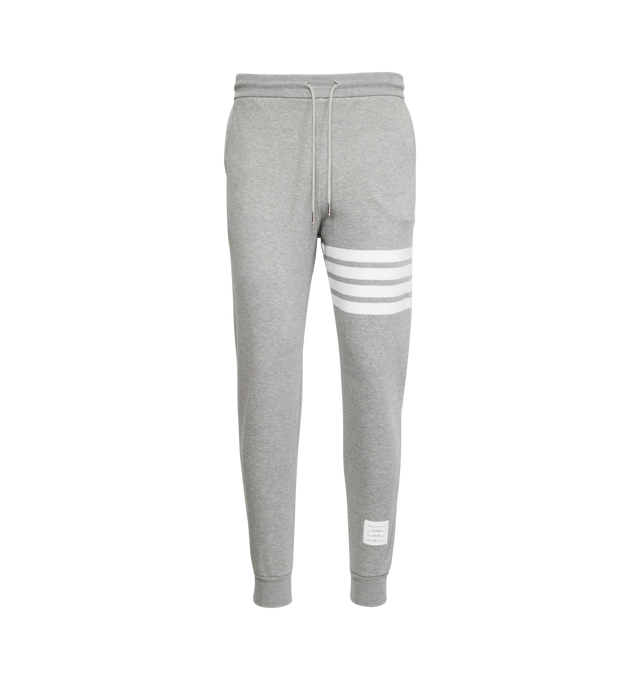 Image 1 of 5 - GREY - THOM BROWNE cotton jersey sweatpants with pull-on waist featuring drawcords, side pockets and slim leg with signature stripes, logo patch and cuffed hems.  