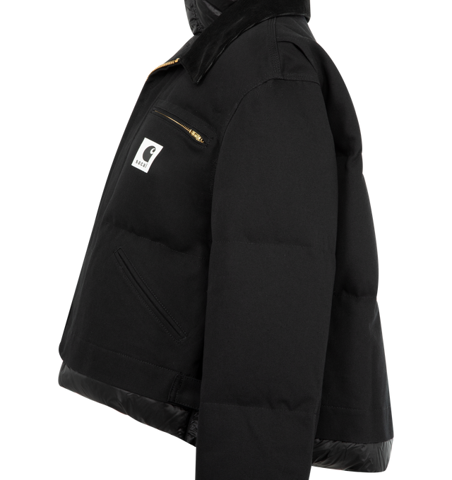 Image 3 of 3 - BLACK - Sacai x Carhartt WIP Duck Puffer Jacket in a boxy, cropped fit and layered silhouette combining a signature canvas exterior with a plush quilted nylon interior. Features stand collar and spread collar, long sleeves, elasticized snap cuffs, chest zip pocket, side patch pockets, concealed snap, two-way front zip closure, finished with a co-branded woven label. Cotton outer, 100% nylon and 100% cupro lining, 90% duck down/10% duck feather fill. Made in Japan.