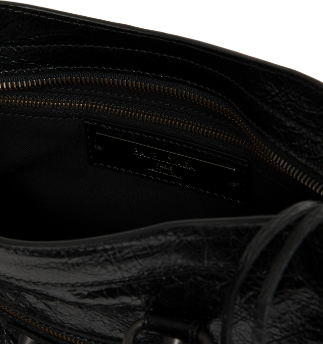 Image 3 of 3 - BLACK - Balenciaga Women's Le City Small Bag is crafted from supple leather and features the house's iconic slouchy silhouette with rolled top handles, signature buckle detailing, and an adjustable, detachable shoulder strap for versatile styling. Designed with a spacious zip-top main compartment, this designer handbag blends Balenciaga's archival motorcycle-inspired aesthetic with everyday functionality. Main Material: Leather. Dimensions: 30 x 19 x 10 cm. Made in Italy.