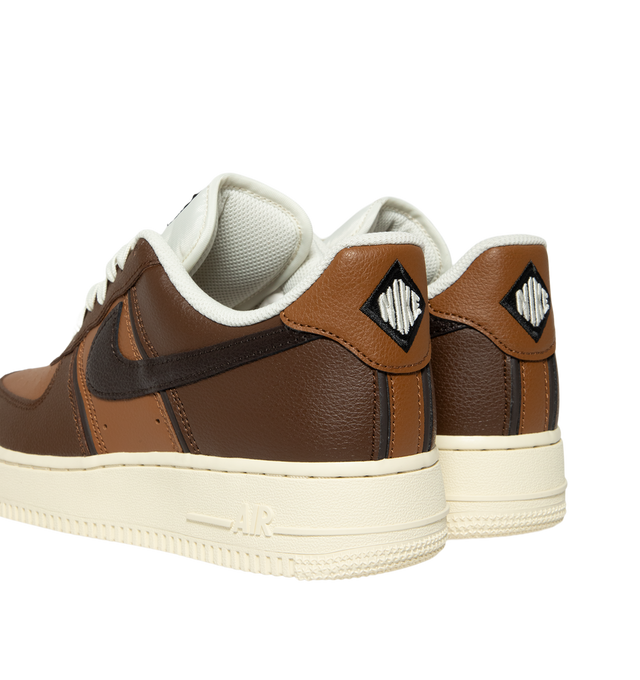 Image 3 of 5 - BROWN - Nike Men's Air Force 1 '07 LV8 Sneaker featuring classic silhouette with genuine and synthetic leather upper with perforated toe box, Nike Air unit, rubber outsole with classic pivot circles and padded collar.