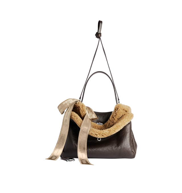 Image 3 of 4 - BROWN - BALENCIAGA Rodeo Handbag Medium in brown calfskin and beige shearling, aged-silver hardware featuring one handle, removable shoulder strap, removable cloche cls with two split rings, ribbon with Balenciaga logo on the front, turn lock closure, wide front pocket, 1 main compartment, 1 inner zipped pocket, 2 flat pockets at back, side snaps, 4 brass feet and Nappa lambskin lining. 13.8" x 9.6" x 4.3". Shearling, calfskin, polyester. Made in Italy.
