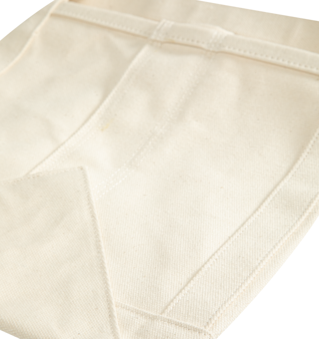 Image 2 of 2 - NEUTRAL - Carhartt WIP Magazine Canvas Basket is crafted from coated cotton canvas and features a structured storage silhouette with two top handles and durable triple-stitched construction. Designed for organizing magazines, books, and everyday essentials, this versatile basket is finished with graphic logo lettering for a signature Carhartt WIP touch. Main Material: 100% Cotton Canvas, 500 gsm. Dimensions: 33 x 25 x 25 cm / 13.0 x 9.8 x 9.8 in. Handles: Dual Top Handles. Details: Coated Can