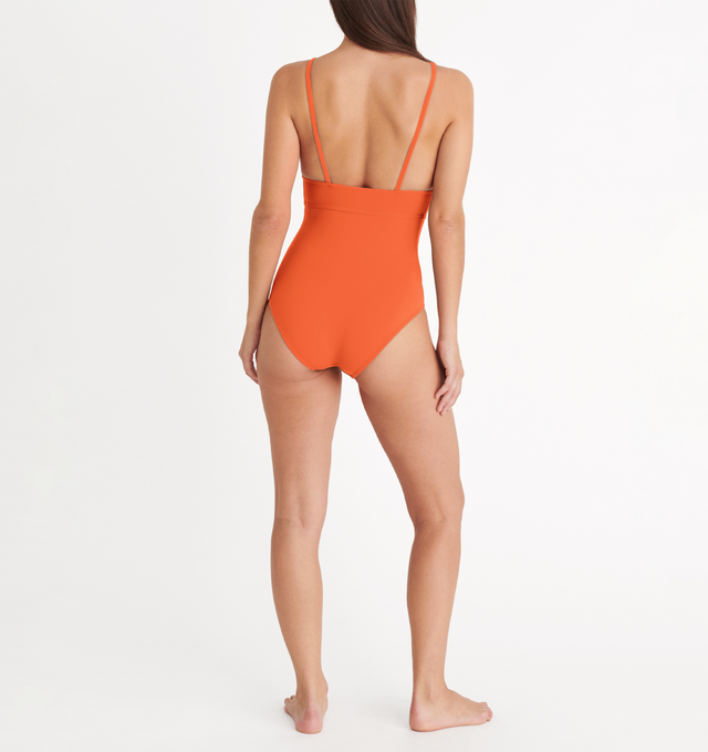 Image 5 of 6 - ORANGE - ERES Larcin One-Piece Triangle Swimsuit featuring thin straps, V-neckline and underbust seam. 84% Polyamid, 16% Spandex. Made in France. 