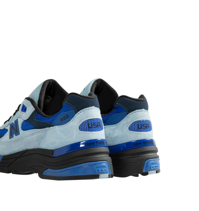 Image 3 of 5 - BLUE - New Balance Unisex Made in USA 992 Sneakers feature a timeless silhouette that blends premium craftsmanship with advanced comfort technology. A fan-favorite since its introduction, this seasonal edition showcases a tonal blue upper crafted from breathable mesh and premium suede overlays, contrasted by a black sole unit. ABZORB cushioning at the heel and forefoot provides exceptional impact absorption, while the ENCAP and C-CAP midsole combination delivers lightweight support and stabil
