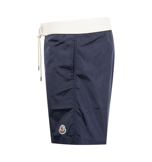 Image 3 of 3 - NAVY - MONCLER Contrast-Band Swim Shorts featuring elasticized drawstring waist, regular rise, side slip pockets, back flap pocket, relaxed legs, logo emblem on left leg and pull-on style. Nylon. Lining: Elastane/nylon.