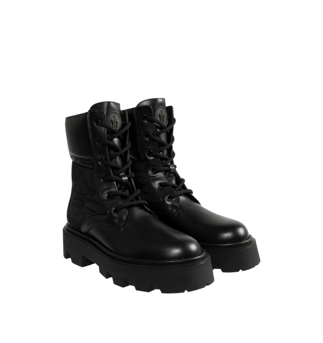 Image 2 of 5 - BLACK - Moncler Womens Aurea Ankle Boots are crafted from leather with polyamide and nylon accents and feature a round toe, lace-up closure, leather lining, and a durable elastodiene sole. These designer ankle boots combine a classic lace-up silhouette with performance-inspired detailing for versatile everyday wear. Main Material: Leather, Polyamide, Nylon; Lining: Leather; Sole: Elastodiene. Made in Italy.