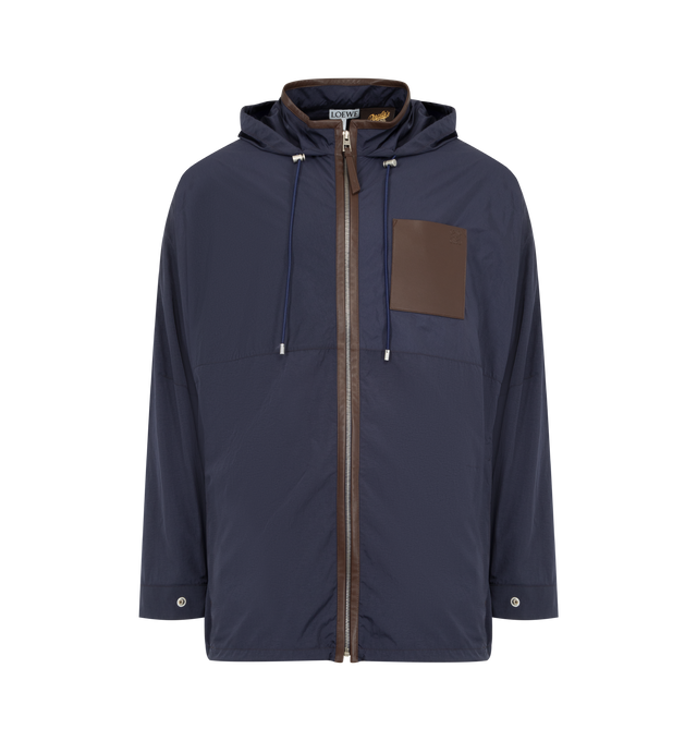 Image 1 of 3 - NAVY - LOEWE PAULA'S IBIZA Hooded Jacket in lightweight technical textured micro ripstop featuring a back vent, relaxed fit, regular length, hooded straight collar with drawstring, leather-trimmed zip front fastening with leather puller, leather-trimmed elasticated drawstring hem, lined hood, seam zipped pockets, leather chest patch pocket, leather-trimmed snap button cuffs and anagram embossed on the chest pocket. Polyamide. Made in Italy.