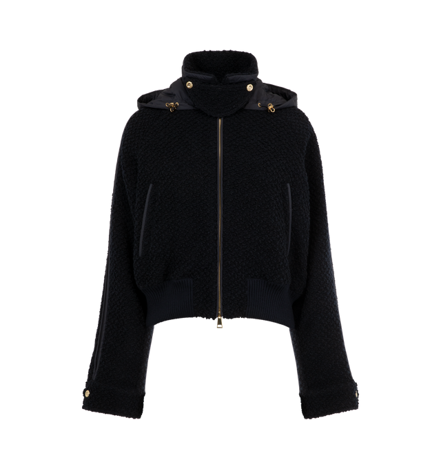 Image 1 of 4 - NAVY - MONCLER Juvigny Hooded Tweed Bomber Jacket featuring piped trims and gold-tone hardware, detachable, adjustable hood, point collar with throat latch, long raglan sleeves with snap cuffs, signature leather logo patch at left sleeve, slip pockets, classic fit, rib-knit hem and two-way zip-front. Virgin wool, polyester, leather. Fill: Down/feather.