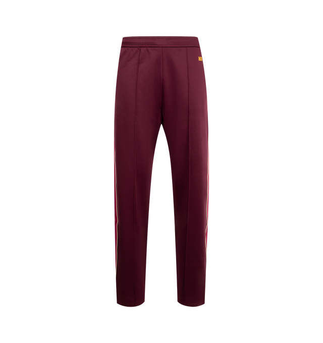 Image 1 of 3 - RED - WALES BONNER Essence Track Pants featuring concealed drawstring at elasticized waistband, three-pocket-styling, mock-fly, pinched seam at legs, stripe down outseams and logo embroidered. 55% polyester, 45% cotton.