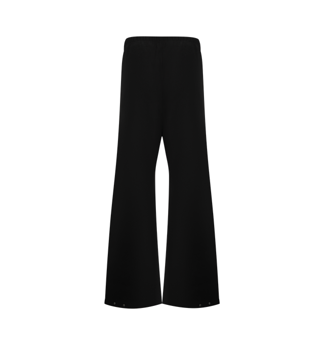 Image 2 of 3 - BLACK - FEAR OF GOD ESSENTIALS Bonded Canvas Work Pant crafted from a bonded stretch fabric featuring loose leg fit, side pockets, an encased elastic waistband with drawstrings, and metal snap hardware at the bottom hem. Additionally, a "Fear of God Essentials" rubberized label is stitched at the center front. 94% polyester, 6% spandex.