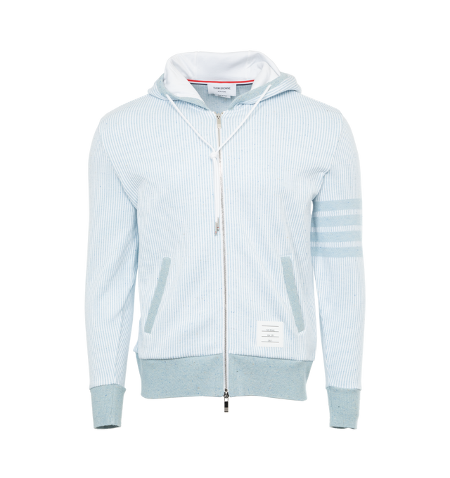 Image 1 of 3 - BLUE - THOM BROWNE Zip Up Hoodie featuring non-detachable hood with drawstring, front zip closure, ribbed cuffs and hem, sleeve striped logo detail, logo patch detail and two side pockets. 99% cotton, 1% silk. Made in Italy. 