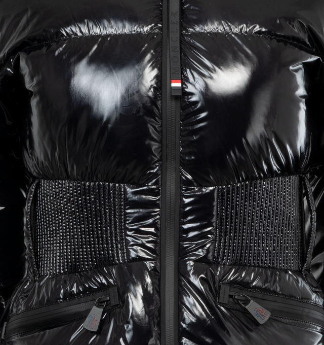 Image 4 of 4 - BLACK - MONCLER GRENOBLE Rochers Short Down Jacket featuring nylon laqu lining, down-filled, pull-out hood with visor, water-repellent look two-way zipper closure, water-repellent look zipped outer pockets, water-repellent look zipped inner media pocket, water-repellent look zipped ski pass pocket, powder skirt, elastic waistband, jersey wrist gaiters and adjustable cuffs. 100% polyamide/nylon. Padding: 90% down, 10% feather. Made in Turkey. 