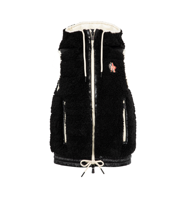 Image 1 of 2 - BLACK - MONCLER GRENOBLE Teddy Fleece Puffer Vest featuring hooded neckline with adjustable drawstrings, two-way zipper closure, sleeveless, embroidered chest logo patch, side zipped pockets and elasticized drawstring hem. Nylon/polyamide/polyester. Fill: down/feather.