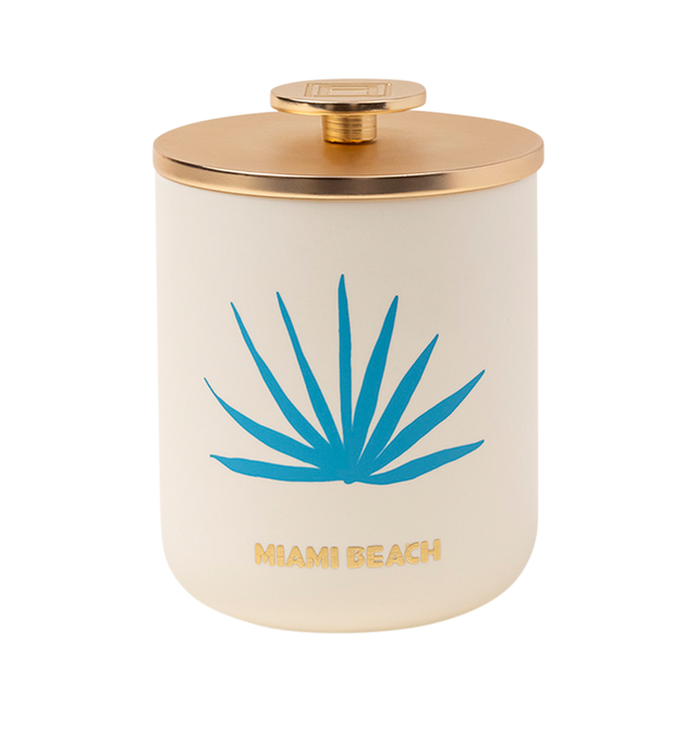 Image 3 of 5 - MULTI - Assouline Miami Beach - Travel From Home Candle. Its an everlasting summer with sun-drenched notes of bergamot, juicy peach, and smooth pistachio that capture the essence of sun-kissed beaches and lively summer beach parties. A heart of blooming florals intertwines with the balmy essence of sandalwood, creating a captivating aroma that embodies the spirited atmosphere and warmth of Miami's sultry nights. Material: Ceramic Vessel. Wax Family: Soy, Coco, Paraffin Blend. Approximate Bur