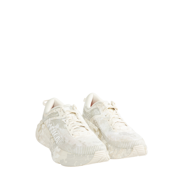 Image 2 of 5 - WHITE - Hoka Unisex Bondi 7 Beams Sneakers reinterpret the ultra-cushioned silhouette with a custom camouflage upper inspired by Japanese Zen gardens. The vegan open-mesh construction features a memory foam collar, TPU overlays, 3D-printed logos, a reflective secondary lace, and a lace keeper. Upper: Vegan Mesh and TPU. *Unisex style in men's sizing.