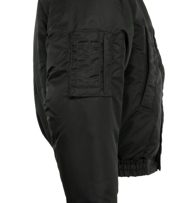 Image 3 of 3 - GREEN - Canada Goose Men's Windrow Bomber is crafted from durable recycled poly twill and features an intentionally oversized, hip-length silhouette designed for flexible all-season wear. Filled with 750 fill power responsibly sourced down, this bomber is equipped with an adjustable hood, concealed snap placket over a front zip closure, rib-knit cuffs and hem, and adjustable snap cuffs to help retain warmth. Functional details include a bicep pocket on the right sleeve, two exterior welt pock