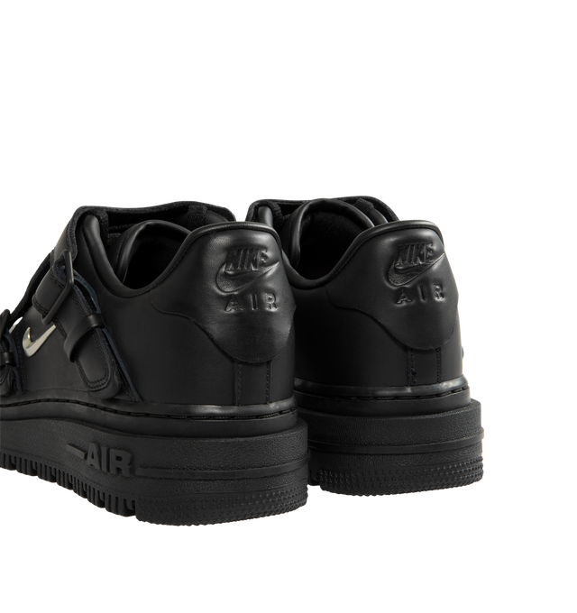 Image 3 of 5 - BLACK - Nike Men's Air Force 1 LX Shoes are crafted from genuine leather and feature the iconic Air Force 1 silhouette with a metallic Swoosh logo and leather lace cover for an elevated finish. The leather upper softens over time, while a Nike Air unit delivers lightweight cushioning. A foam midsole enhances comfort, and the rubber outsole with classic pivot-circle traction provides durability and grip. Upper: Genuine Leather. Midsole: Foam with Nike Air cushioning. Outsole: Rubber.
