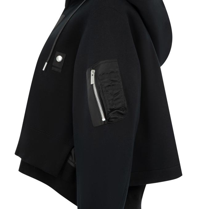 Image 3 of 3 - BLACK - SACAI Sponge Sweat x Nylon Twill Hoodie featuring padded cotton-blend jersey hoodie, drawstring at hood, two-way zip closure, logo-engraved press-stud tab at chest, concealed welt pockets, rib-knit hem and cuffs, cropped hem, utility pocket and pen slots at sleeve, dropped shoulders and nylon satin underlay. 62% cotton, 38% polyester. Lining: 55% polyester, 44% cotton, 1% polyurethane. Fill: 100% polyester. Made in Japan.