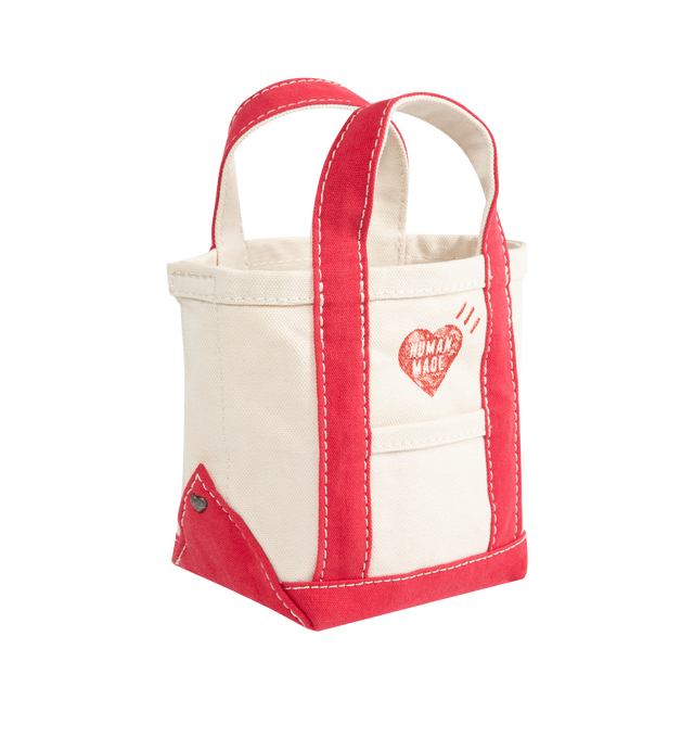 Image 2 of 3 - WHITE - HUMAN MADE Small Canvas Tote Bag featuring fleece-tough cotton canvas, wash finish creating a textured wrinkled look, seeped-in graphic, contrasting color accents on the handles and bottom, heart-shaped rivets on the side seams and external pocket attached to the side with the heart logo. 100% cotton.