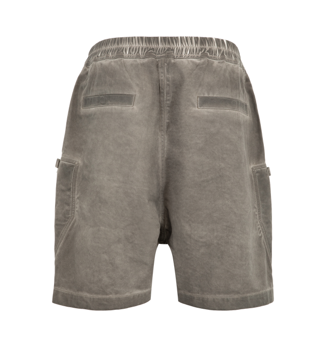 Image 2 of 3 - GREY - Rick Owens Drkshdw Men's Bauhaus Shorts are crafted from 100% cotton 13oz Lido Wash denim and feature a knee-length silhouette with a low dropped crotch. Designed with an elasticized waistband and drawstring closure, these designer shorts include side pockets, signature round Bauhaus zip pockets at the front thigh, and a webbing tab with eyelet detailing. Back jet pockets complete the utilitarian design. The medium-weight denim is overdyed and stone washed to achieve an irregular, live