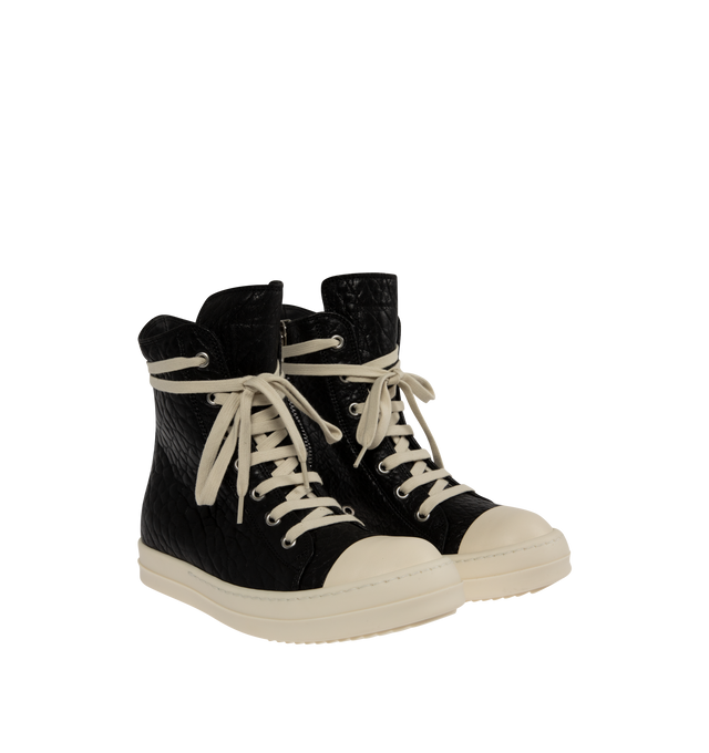 Image 2 of 5 - BLACK - Rick Owens Womens High-Top Sneakers are crafted from textured leather. Feature an above-ankle silhouette, seven-eyelet lace-up closure, inner ankle zip, calf leather toe cap, and signature shark-tooth thermoplastic rubber outsole. Upper: 100%Leather; Toe: 100% Calf Leather; Lining: 100% Calf Leather; Insole: 100% Calf Leather; Outsole: 100% Thermoplastic Rubber. Sole Height: 3.5 cm. Made in Italy.
