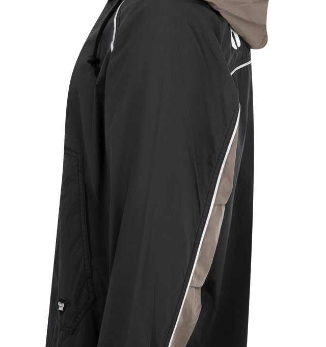 Image 3 of 3 - BLACK - HUMAN MADE Nylon Anorak Jacket featuring half-zip, wrinkled texture, packable hood with snap buttons on the collar, brand logo graphics, heart logo patch on the left chest, sleeve cut-outs, kangaroo pocket with a flap pocket and drawcord allows for silhouette adjustments. 80% cotton, 20% nylon.
