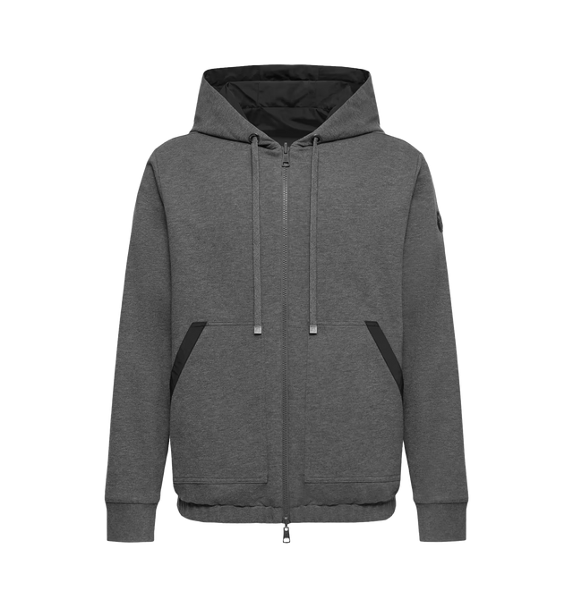 Image 1 of 1 - GREY - Moncler Mens Reversible Zip-Up Hoodie is crafted from cotton fleece with a polyester reverse side. Features a loose fit, reversible design, hood, fleece pockets with nylon trim, welt pockets on the reverse side, and double leather logo patch. Base Fabric: 100% Cotton; Lining: 100% Polyester; Hood Lining: 100% Polyester; Ribbed Cuffs: 95% Cotton, 5% Elastane/Spandex; Detail Padding: 100% Polyester; Leather Tag: Cow Leather. Made in Moldova.