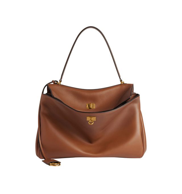 Image 1 of 5 - BROWN - BALENCIAGA Rodeo Top Handle Bag featuring a turn lock closure, a single top handle for hand carrying, an adjustable shoulder strap, side snaps, brass feet, a removable leather keychain holder, a wide front pocket and an interior zipper pocket. 13.8 X 9.2 X 4.3 inches. 100% calfskin. Made in Italy.