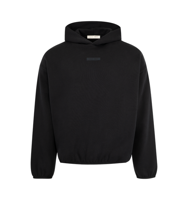 Image 1 of 3 - BLACK - FEAR OF GOD ESSENTIALS Modern Fleece Hoodie featuring 380gsm core fleece, modern fit forming wider relaxed proportions with a cropped length, rubberized labels on the center front and sleeve, double-layer hoodie, side pockets, and elasticized piping on the cuffs and waist hem. 80% cotton, 20% polyester fleece.