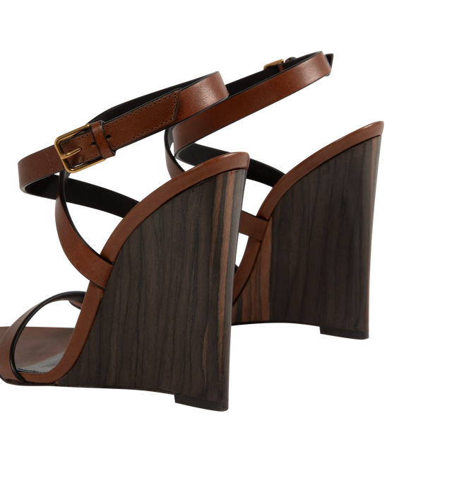 Image 3 of 4 - BROWN - SAINT LAURENT Gippy Wedge Sandal featuring ankle buckle closure, pointed toe and wedge heel. 4.3 inch wedge. Leather upper and sole. Made in Italy.