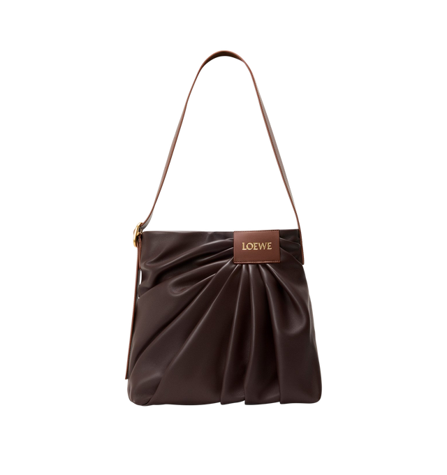Image 1 of 4 - BROWN - LOEWE Draped Tote featuring soft scultpural shape and a wide strap adorned with a bold LOEWE-engraved buckle, shoulder or crossbody carry, adjustable strap, magnetic closure, one internal calfskin patch pocket, herringbone cotton canvas lining and gold embossed LOEWE. Mellow nappa lambskin. 30 cm x 29 cm x 13 cm. Made in Spain. This item may be restricted for online purchase to international clients. For assistance purchasing this item please contact our dedicated stylist team at pers
