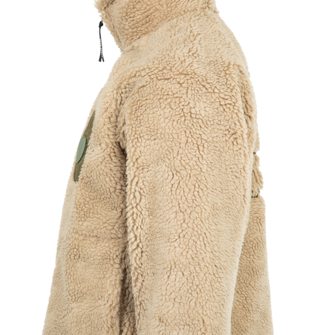 Image 3 of 3 - BROWN - HUMAN MADE Fleece Jacket featuring soft polyester boa fabric, heart-shaped magic tape on the left chest pocket, removing the tape reveals a text graphic, contrasting piping and pockets, chain-stitched animal graphic on the back, heart-shaped snap buttons on the cuffs and mesh lining with wind-proof film. 100% polyester. Contrast: 100% nylon.