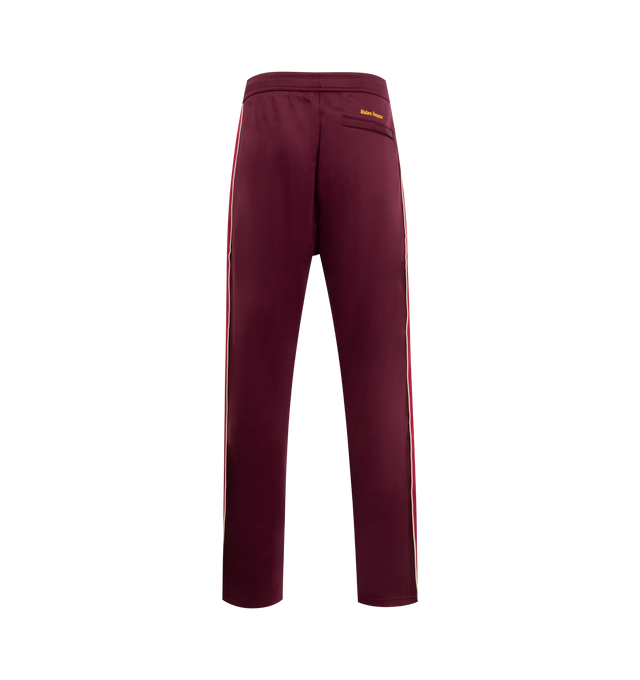 Image 2 of 3 - RED - WALES BONNER Essence Track Pants featuring concealed drawstring at elasticized waistband, three-pocket-styling, mock-fly, pinched seam at legs, stripe down outseams and logo embroidered. 55% polyester, 45% cotton.