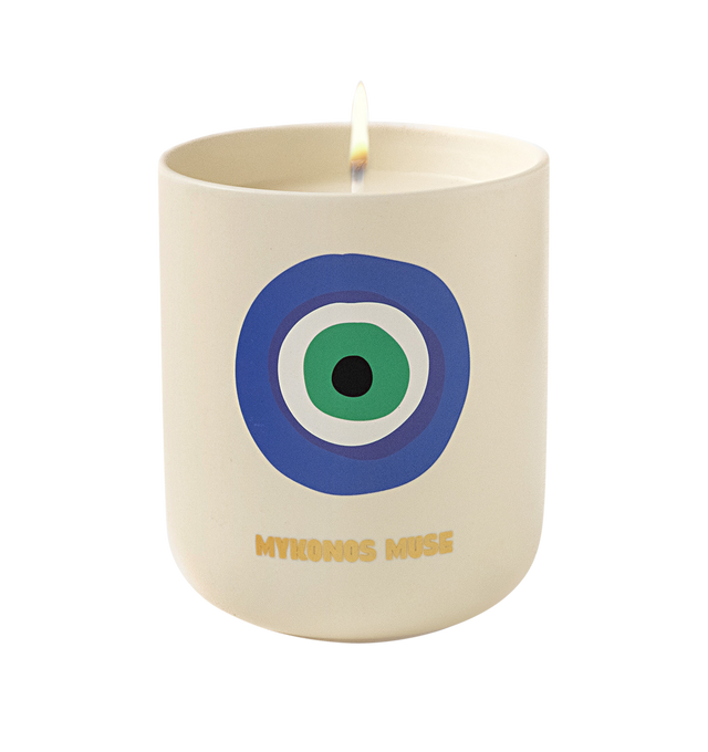 Image 2 of 5 - MULTI - Assouline Mykonos Muse - Travel From Home Candle. Bathe in the idyllic shores of Mykonos with the aroma of fresh green fig, warm tonka, sweet almond, and herbaceous cyclamen, as this exquisite blend evokes the allure of hidden coves and charming whitewashed villas. Material: Ceramic Vessel. Wax Family: Soy, Coco, Paraffin Blend. Approximate Burn Time: 50 Hours. Weight: 11.25 oz (318.02 g). Dimensions: 4 x 3.37 in (10.16 x 8.56 cm).