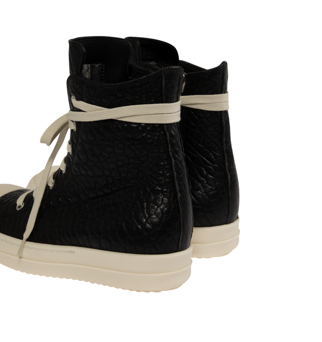 Image 3 of 5 - BLACK - Rick Owens Womens High-Top Sneakers are crafted from textured leather. Feature an above-ankle silhouette, seven-eyelet lace-up closure, inner ankle zip, calf leather toe cap, and signature shark-tooth thermoplastic rubber outsole. Upper: 100%Leather; Toe: 100% Calf Leather; Lining: 100% Calf Leather; Insole: 100% Calf Leather; Outsole: 100% Thermoplastic Rubber. Sole Height: 3.5 cm. Made in Italy.
