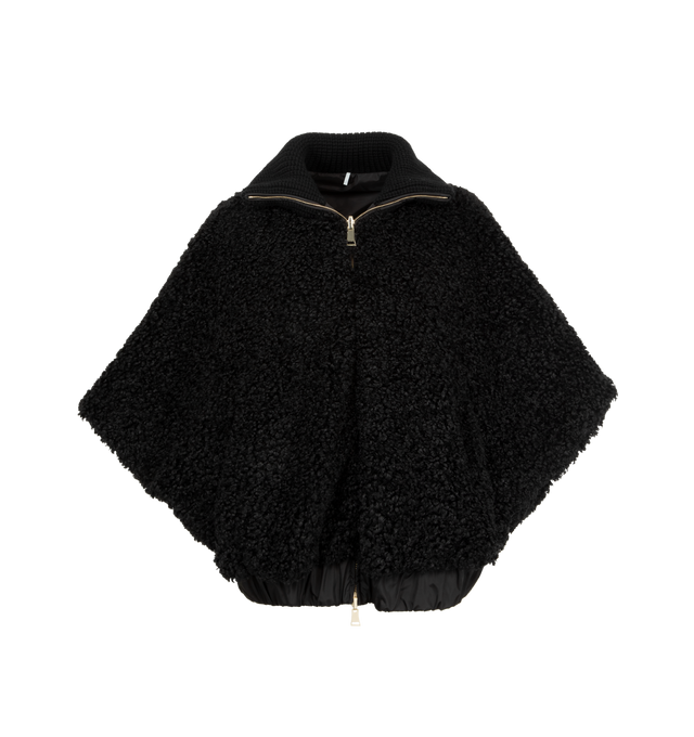 Image 1 of 4 - BLACK - MONCLER Reversible Faux Fur Cape featuring chunky knit collar, two-way zip-front, raglan sleeves, tonal leather logo patch on the left sleeve, relaxed fit, elasticized hem and reverses to a water-resistant recycled polyester. Polyester/leather. Lining: nylon.