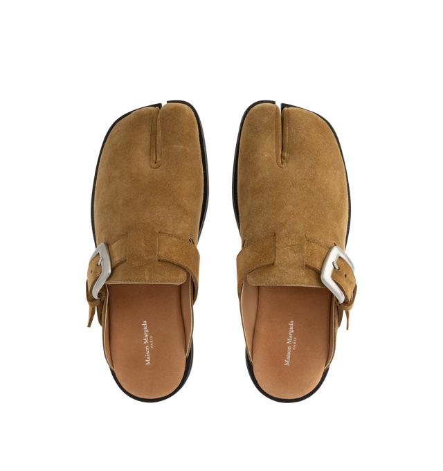 Image 4 of 4 - NEUTRAL - Maison Margiela Women's Tabi Daily Mules are crafted from calf suede and feature the signature split-toe design, a slip-on mule silhouette, open-back construction, an adjustable buckle strap, and a durable rubber sole. These designer suede mules combine the iconic Tabi silhouette with everyday comfort for effortless styling. Main Material: 100% Calf Suede. Lining: 50% Calf Leather, 50% Calf Suede. Sole: 100% Rubber. Heel Height: 1.1 cm. Made in Italy.