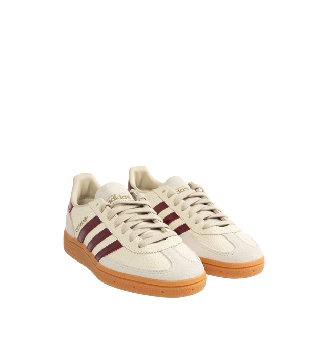 Image 2 of 5 - NEUTRAL - Adidas Men's Handball Spezial Sneakers feature a textured mix of cracked leather, suede overlays, and patent leather 3-Stripes. Designed in a regular fit with a secure lace-up closure, these designer sneakers feature signature Spezial detailing at the quarter and tongue and a soft gum rubber outsole. Upper: Leather. Lining and Insole: Textile and Other Materials. Outsole: Other Materials.
