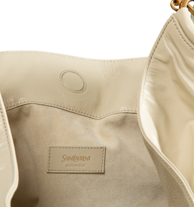 Image 3 of 4 - NEUTRAL - Saint Laurent Womens Hobo Bag is crafted from lustrous calfskin leather. Features a slouchy silhouette, signature Cassandre ring detail, shoulder strap, magnetic closure, removable zip pouch, suede lining, and bronze-tone hardware. Main Material: Calfskin Leather; Lining: Suede; Hardware: Brass. Made in Italy.