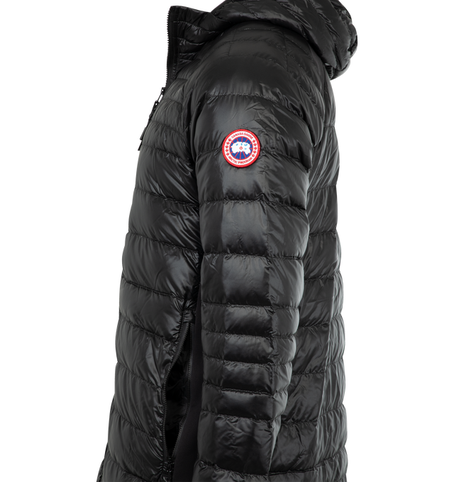 Image 3 of 3 - BLACK - CANADA GOOSE HyBridge Lite Hoody featuring down-filled hood with stretch binding, storm flap underneath two-way zipper, cuffs with discreet thumbhole construction, tricot-lined chin guard, two exterior mesh-lined hand pockets with zipper closures, two interior lower drop-in pockets and packable into wearer's exterior right pocket. 100% recycled polyamide. Fill: 90% down, 10% feathers.