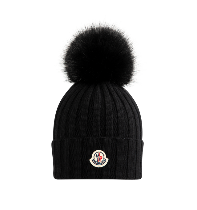 Image 1 of 2 - BLACK - MONCLER Wool Beanie with Pom Pom featuring Merino wool, ribbed knit and faux fur pom pom. 100% virgin wool.