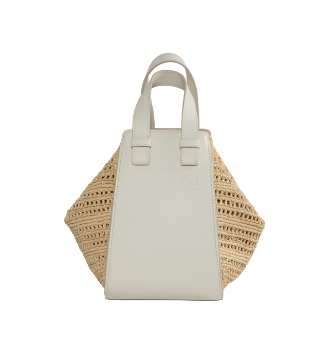 Image 1 of 3 - WHITE - Loewe Paula's Ibiza Compact Hammock bag in raffia and calfskin with supple side panels that release to change its shape, with a distinctive wing design that can be folded in or out to create multiple silhouettes and offer secure fastening thanks to concealed magnetic closures. This compact version is crafted in handwoven raffia and calfskin. Featuring detachable and adjustable strap for shoulder, crossbody or top handle carry, interior hook closure, external zip pocket and two interna 