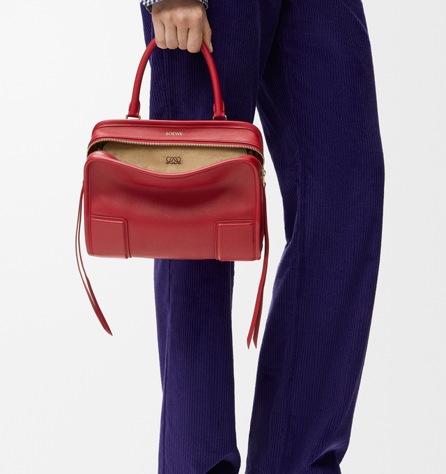 Image 2 of 18 - RED - Loewe Small Amazona 180 Bag in leather features a relaxed silhouette anchored by a single toron top handle, designed to be carried open, while a concealed closure secures the main compartment, three carry options: short handle, removable shoulder strap and crossbody, zip closure with two leather zip pullers, two compartments, main compartment closed with magnetic closure, internal flat pocket, left side d-ring for customization, nappa lambskin lining, and embossed double L branding. Le