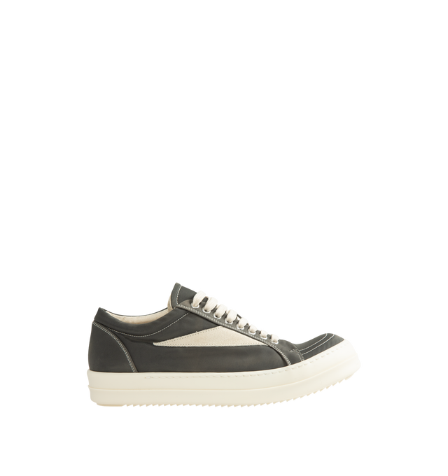 Image 1 of 5 - GREY - Rick Owens DRKSHDW Vintage Sneaks are designed with a low-top design including a lace-up closure, signature shark-tooth soles, and contrast stitching. The medium-weight denim is overdyed for a soft, washed handfeel, while the fabric undergoes responsible treatment processes designed to reduce water consumption. Upper: 100% Cotton. Lateral Details: 100% Calf Leather. Lining: 100% Cotton. Sole: 100% Thermoplastic Rubber. Sole Height: 3.5 cm / 1.4 in. Closure: Lace-Up. Made in Italy.